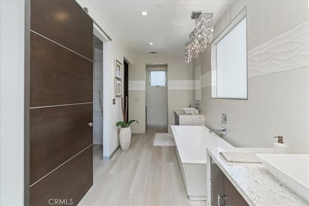 Bathroom, Chandelier, Free Standing Baths, Interior, Pendant Lights, Recessed Lighting, Wood Texture Flooring