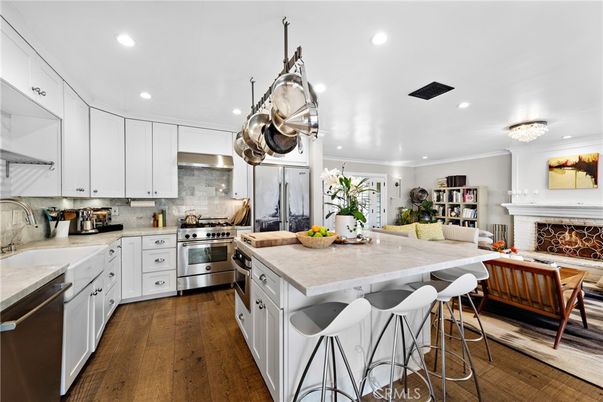 Chandelier, Fireplace, Interior, Kitchen, Living room, Recessed Lighting, Stainless Steel Appliances, Wood Texture Flooring