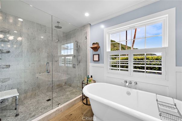 Bathroom, Free Standing Baths, Glass Shower, Interior, Marble Walls, Recessed Lighting, Wood Texture Flooring