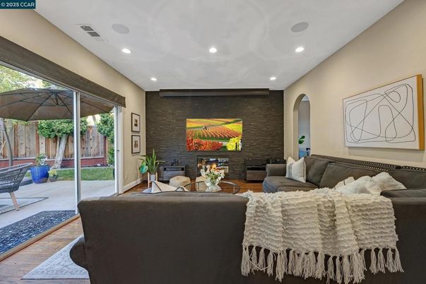 Fireplace, Interior, Living room, Recessed Lighting, Stone Walls, Wood Texture Flooring