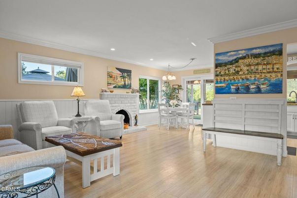 Chandelier, Dining room, Fireplace, Interior, Living room, Pendant Lights, Recessed Lighting, Wood Texture Flooring