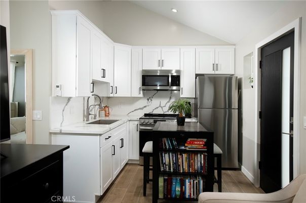 Interior, Kitchen, Marble Walls, Recessed Lighting, Stainless Steel Appliances, Wood Texture Flooring