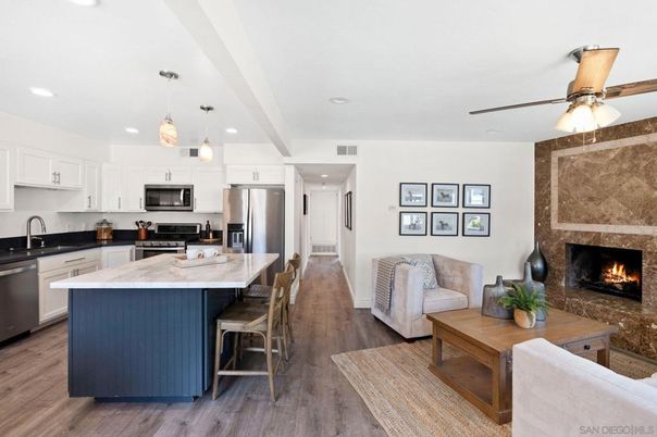 Fireplace, Interior, Kitchen, Living room, Pendant Lights, Recessed Lighting, Stainless Steel Appliances, Wood Texture Flooring