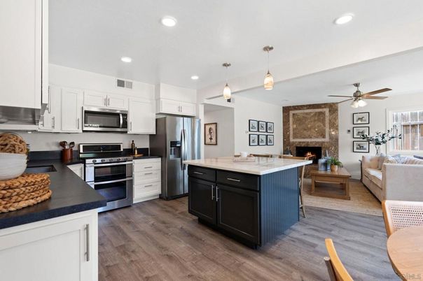 Fireplace, Interior, Kitchen, Living room, Pendant Lights, Recessed Lighting, Stainless Steel Appliances, Stone Walls, Wood Texture Flooring