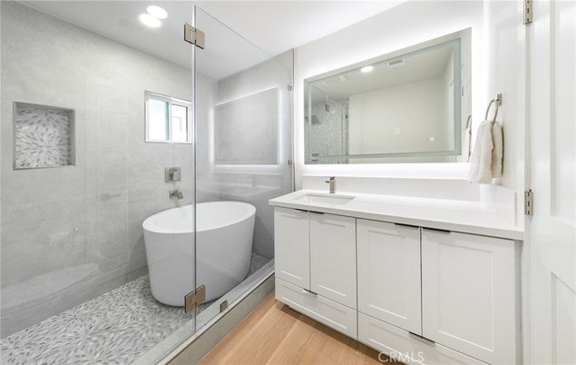 Bathroom, Free Standing Baths, Glass Shower, Interior, Recessed Lighting, Wood Texture Flooring