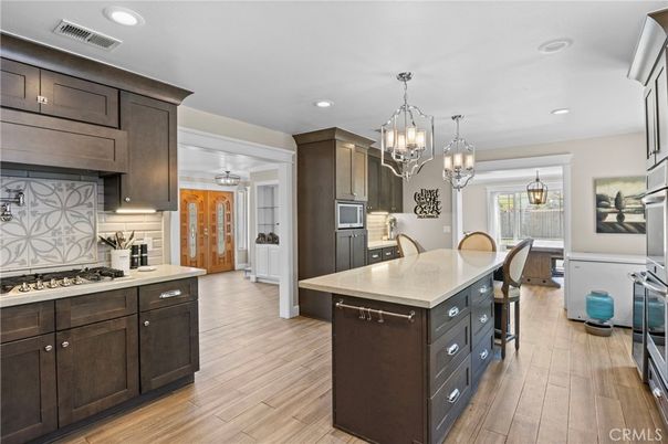 Chandelier, Dining room, Interior, Kitchen, Pendant Lights, Recessed Lighting, Stainless Steel Appliances, Wood Texture Flooring