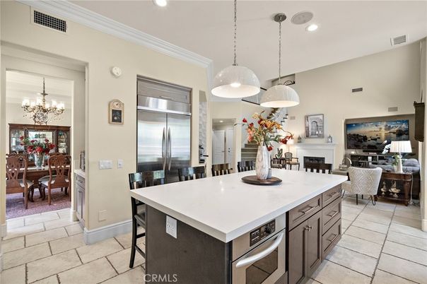 Chandelier, Dining room, Fireplace, Interior, Kitchen, Living room, Pendant Lights, Recessed Lighting, Stainless Steel Appliances