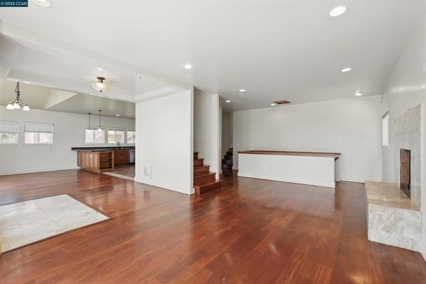 Empty room, Fireplace, Interior, Kitchen, Pendant Lights, Recessed Lighting, Wood Texture Flooring