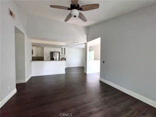 Empty room, Interior, Kitchen, Recessed Lighting, Stainless Steel Appliances, Wood Texture Flooring