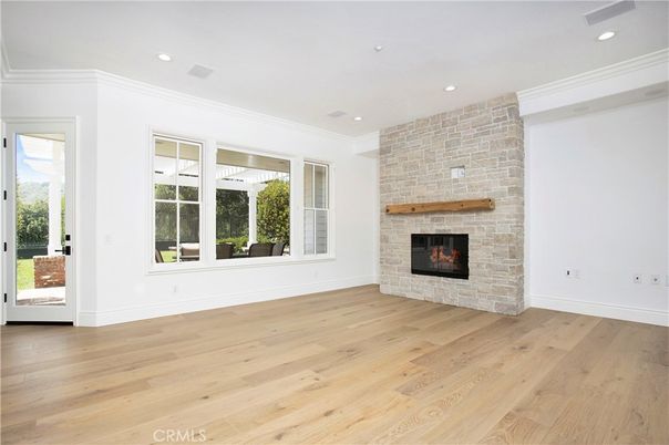 Empty room, Fireplace, Interior, Recessed Lighting, Stone Walls, Wood Texture Flooring