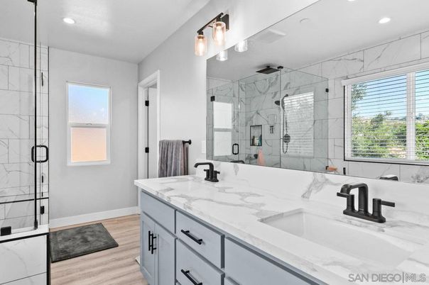 Bathroom, Dual Sink Vanities, Glass Shower, Interior, Marble Walls, Recessed Lighting, Wood Texture Flooring