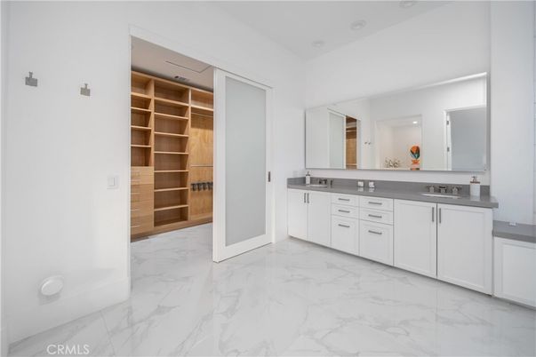 Bathroom, Dual Sink Vanities, Interior, Marble, Recessed Lighting, Walk-in Closets