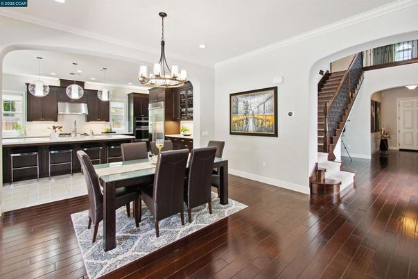 Chandelier, Dining room, Interior, Kitchen, Pendant Lights, Recessed Lighting, Stainless Steel Appliances, Wood Texture Flooring