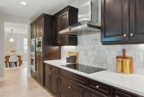 Chandelier, Dining room, Interior, Kitchen, Pendant Lights, Recessed Lighting, Stainless Steel Appliances, Wood Texture Flooring