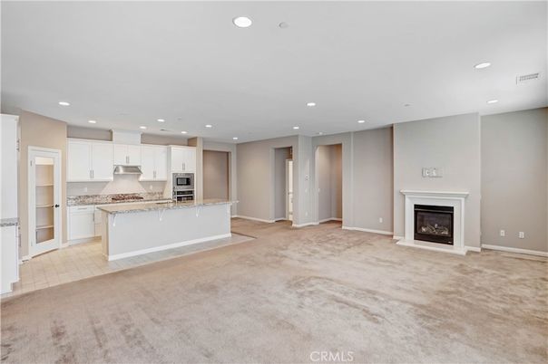 Empty room, Fireplace, Interior, Kitchen, Recessed Lighting, Stainless Steel Appliances