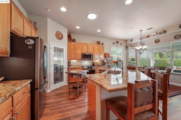 Chandelier, Dining room, Interior, Kitchen, Recessed Lighting, Stainless Steel Appliances, Wood Texture Flooring