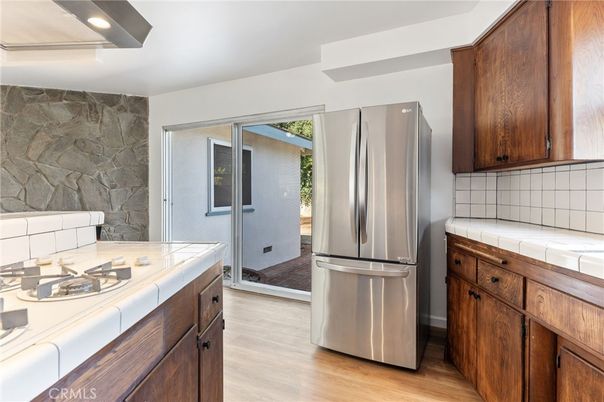 Interior, Kitchen, Recessed Lighting, Stone Walls, Tile Countertops, Wood Texture Flooring