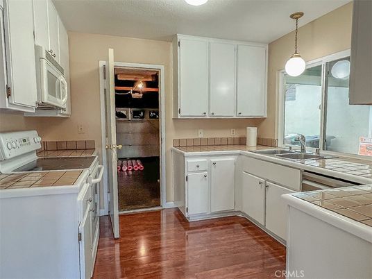 Interior, Kitchen, Pendant Lights, Tile Countertops, Wood Texture Flooring