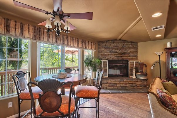 Dining room, Fireplace, Interior, Recessed Lighting, Stone Walls, Wood Texture Flooring