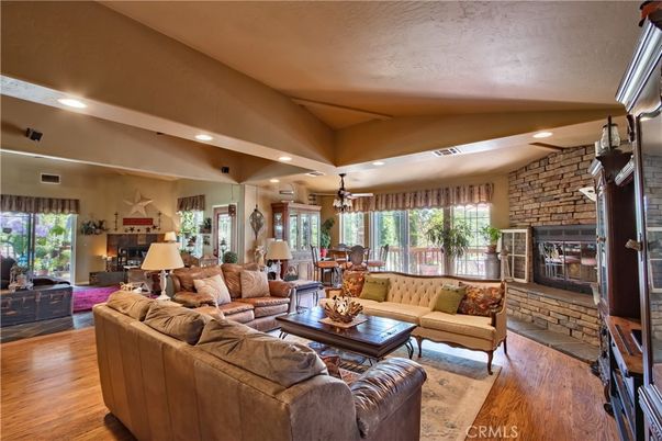Dining room, Fireplace, Interior, Living room, Recessed Lighting, Stone Walls, Wood Texture Flooring
