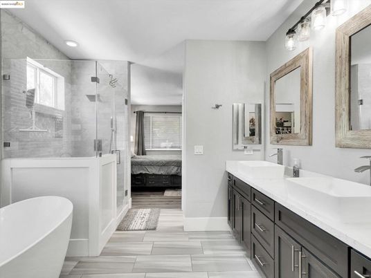 Bathroom, Dual Sink Vanities, Free Standing Baths, Glass Shower, Interior, Marble Walls, Recessed Lighting, Wood Texture Flooring