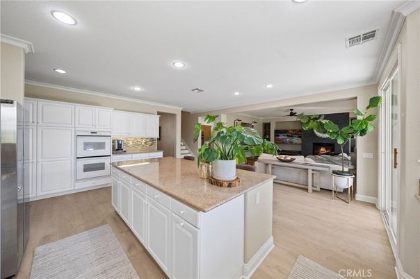 Fireplace, Interior, Kitchen, Recessed Lighting, Stainless Steel Appliances, Wood Texture Flooring