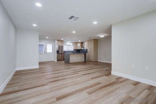Empty room, Interior, Kitchen, Recessed Lighting, Stainless Steel Appliances, Wood Texture Flooring