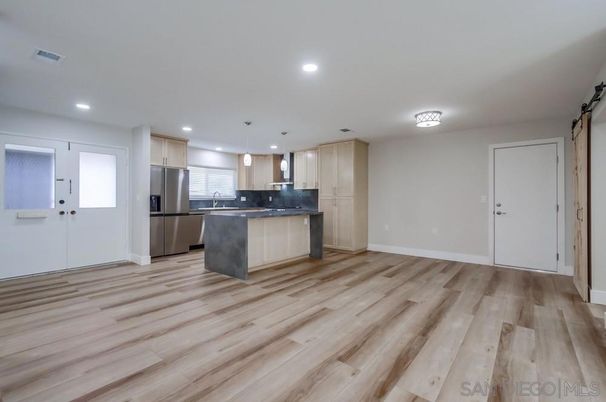 Empty room, Interior, Kitchen, Recessed Lighting, Stainless Steel Appliances, Wood Texture Flooring