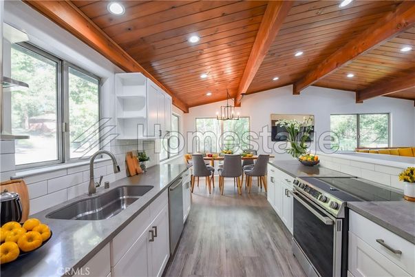 Chandelier, Dining room, Interior, Kitchen, Recessed Lighting, Stainless Steel Appliances, Wooden Beams, Wooden Ceilings, Wood Texture Flooring