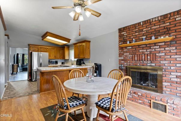 Dining room, Fireplace, Interior, Kitchen, Stainless Steel Appliances, Stone Walls, Wood Texture Flooring