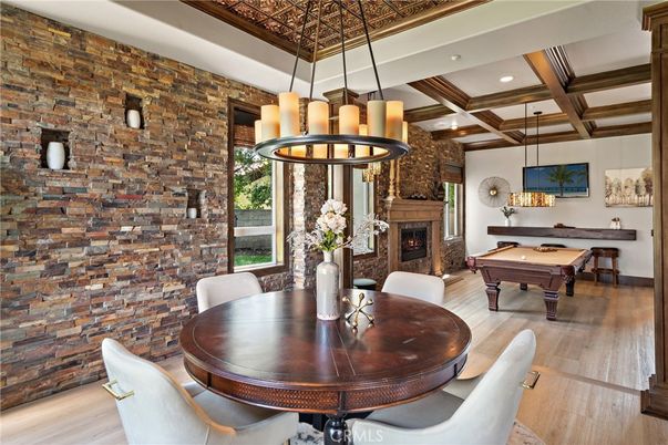 Billiard Table, Chandelier, Dining room, Fireplace, Game Room, Interior, Pendant Lights, Recessed Lighting, Stone Walls, Wooden Beams, Wood Texture Flooring