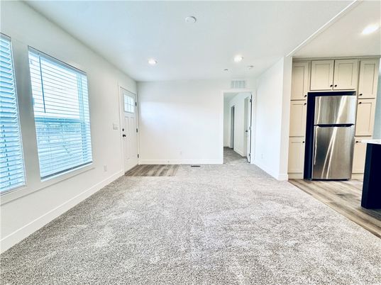 Empty room, Interior, Kitchen, Recessed Lighting, Stainless Steel Appliances, Wood Texture Flooring