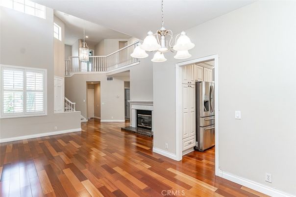 Chandelier, Fireplace, Interior, Kitchen, Pendant Lights, Stainless Steel Appliances, Wood Texture Flooring
