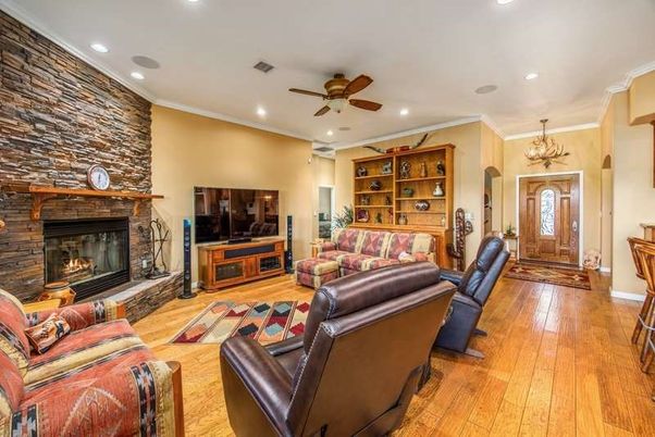 Chandelier, Fireplace, Interior, Living room, Recessed Lighting, Stone Walls, Wood Texture Flooring