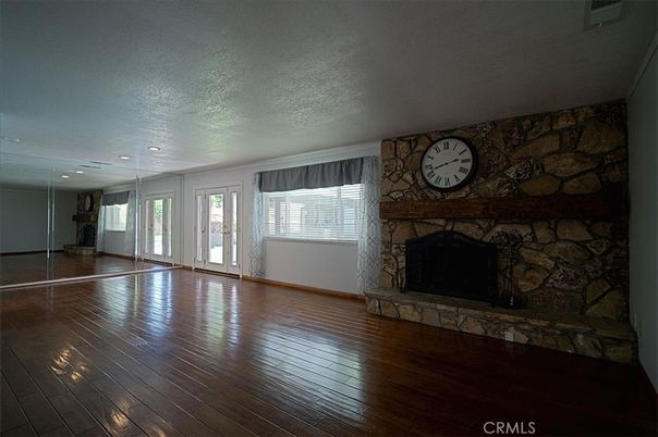 Empty room, Fireplace, Interior, Recessed Lighting, Stone Walls, Wood Texture Flooring