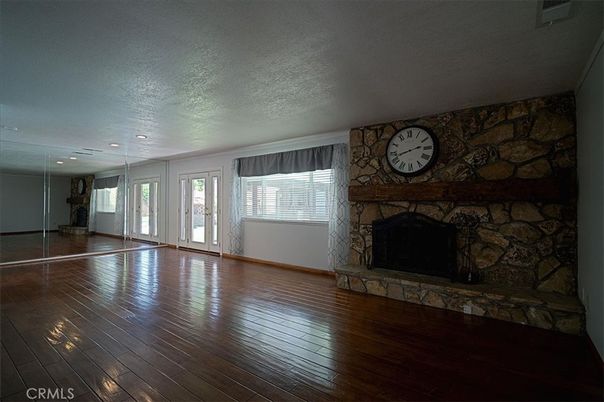 Empty room, Fireplace, Interior, Recessed Lighting, Stone Walls, Wood Texture Flooring