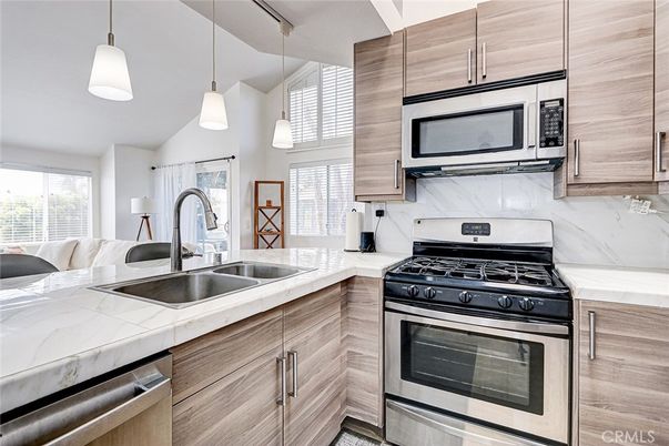 Interior, Kitchen, Pendant Lights, Stainless Steel Appliances, Tile Countertops, Wood Texture Flooring