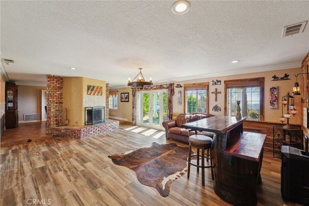 Dining room, Fireplace, Interior, Living room, Pendant Lights, Recessed Lighting, Wood Texture Flooring