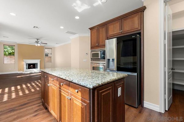 Fireplace, Interior, Kitchen, Recessed Lighting, Stainless Steel Appliances, Wood Texture Flooring