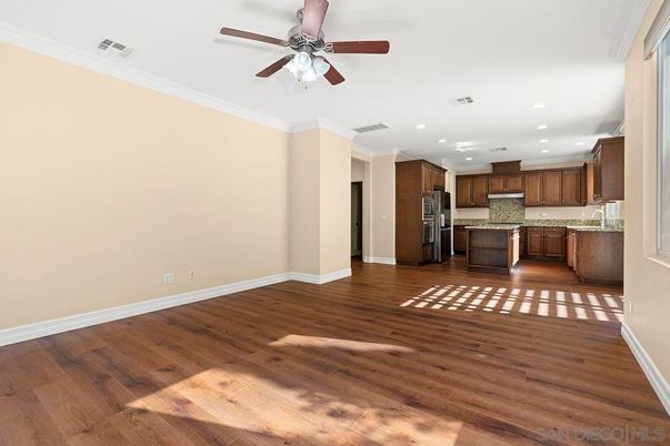 Empty room, Interior, Kitchen, Recessed Lighting, Stainless Steel Appliances, Wood Texture Flooring