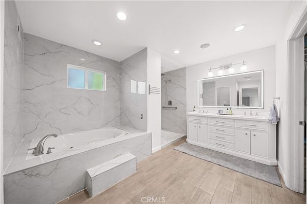 Bathroom, Dual Sink Vanities, Interior, Marble Walls, Recessed Lighting, Wood Texture Flooring