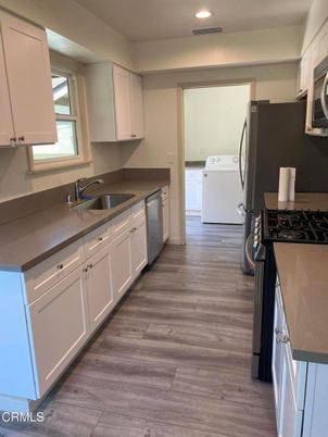 Interior, Kitchen, Recessed Lighting, Washer, Wood Texture Flooring