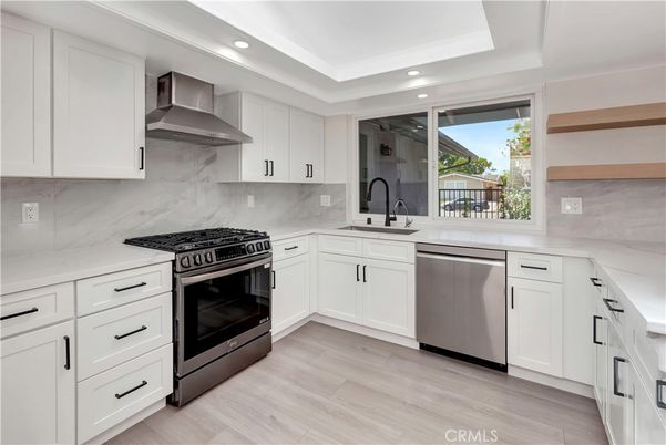 Interior, Kitchen, Marble Walls, Recessed Lighting, Stainless Steel Appliances, Wood Texture Flooring