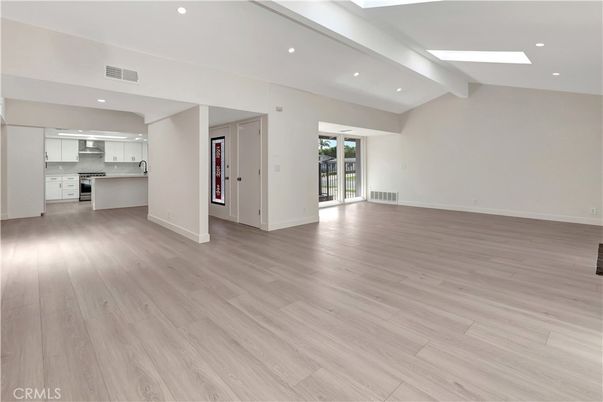 Empty room, Interior, Kitchen, Recessed Lighting, Stainless Steel Appliances, Wood Texture Flooring