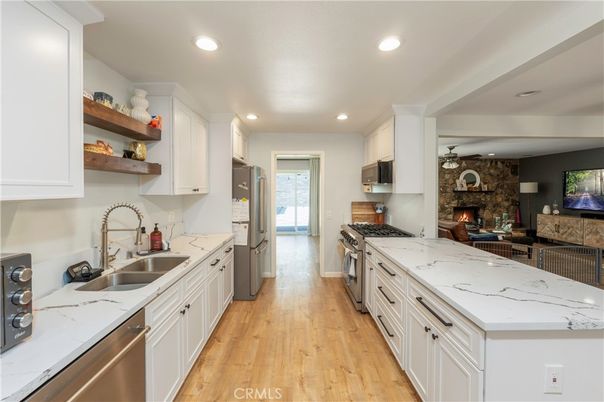 Fireplace, Interior, Kitchen, Recessed Lighting, Stainless Steel Appliances, Stone Walls, Wood Texture Flooring