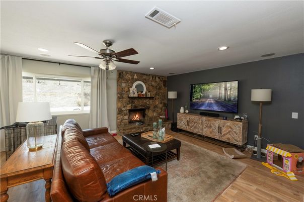 Fireplace, Interior, Living room, Recessed Lighting, Stone Walls, Wood Texture Flooring
