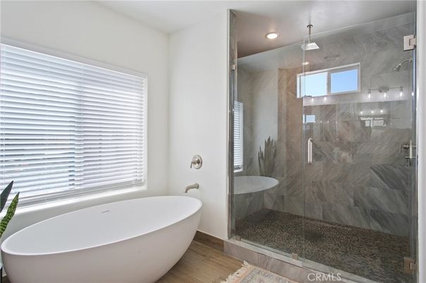 Bathroom, Free Standing Baths, Glass Shower, Interior, Marble Walls, Recessed Lighting, Wood Texture Flooring