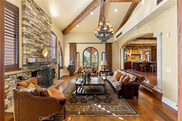 Chandelier, Dining room, Fireplace, Interior, Living room, Recessed Lighting, Stone Walls, Wooden Beams, Wood Texture Flooring