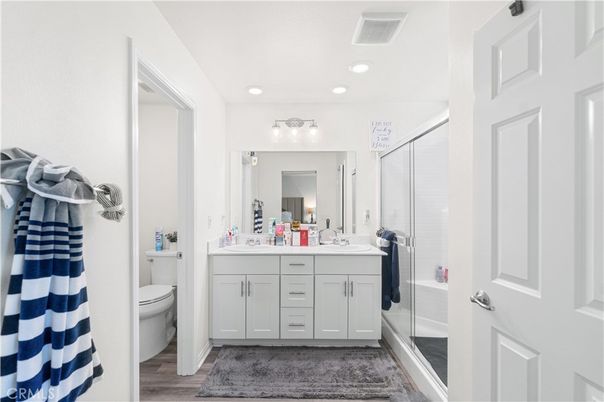 Bathroom, Dual Sink Vanities, Glass Shower, Interior, Recessed Lighting, Wood Texture Flooring