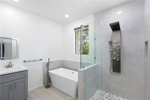 Bathroom, Free Standing Baths, Glass Shower, Interior, Recessed Lighting, Wood Texture Flooring